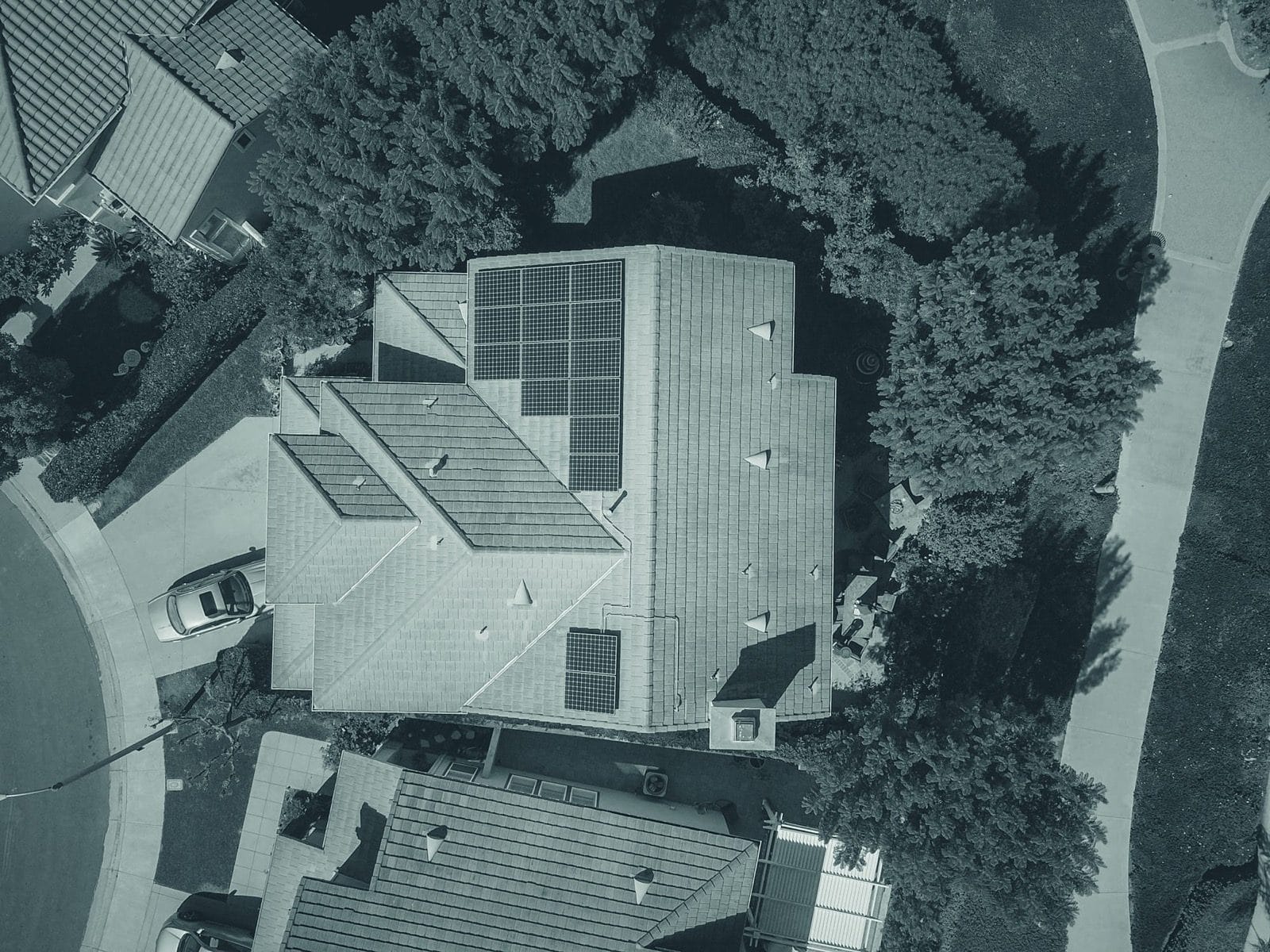 Drone view of a house with rooftop solar panels