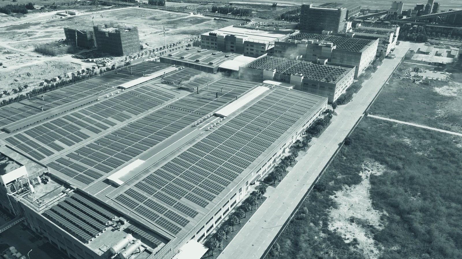 Aerial view of an industrial roof with solar panels