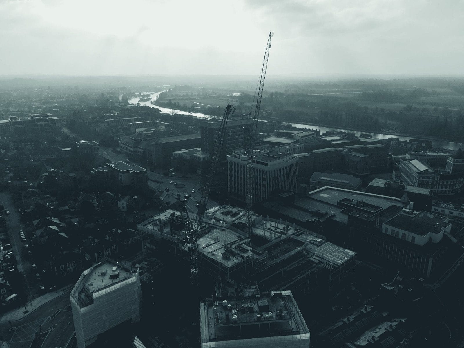 Aerial view of a construction site with cranes in Kingston upon Thames