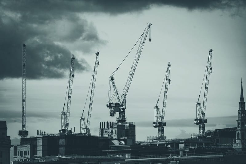 Aerial view of a London construction site with tower cranes