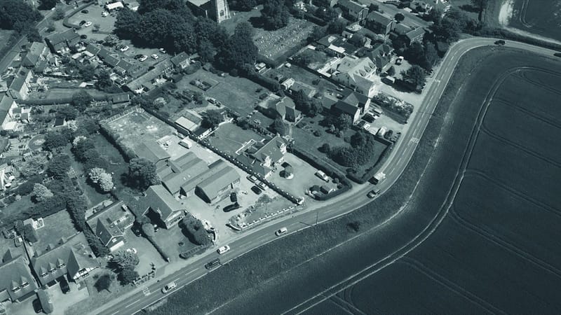 Aerial view of an English village and surrounding fields